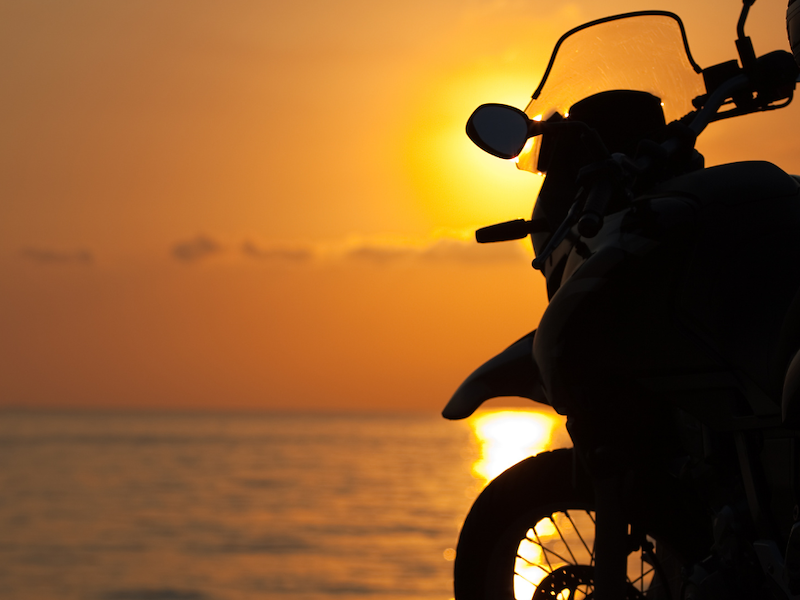 motorcycle on the beach at sunset
