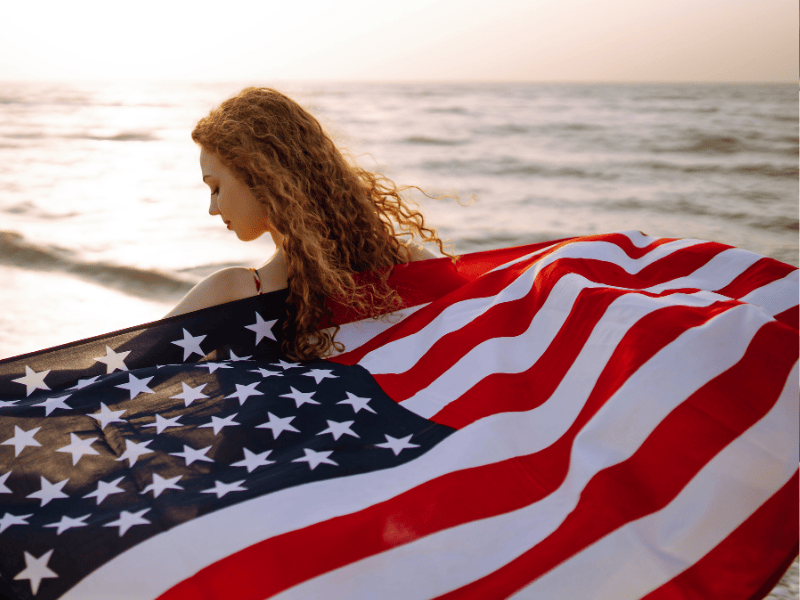 woman flying an american flag behind her