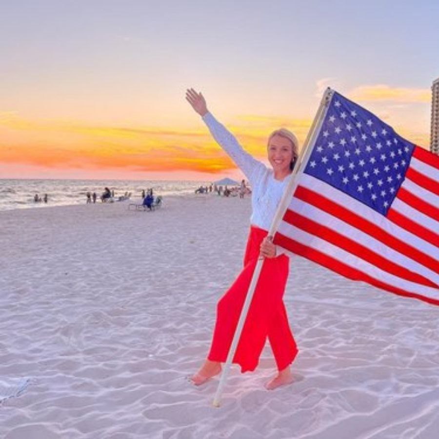 woman on the beach with american flag